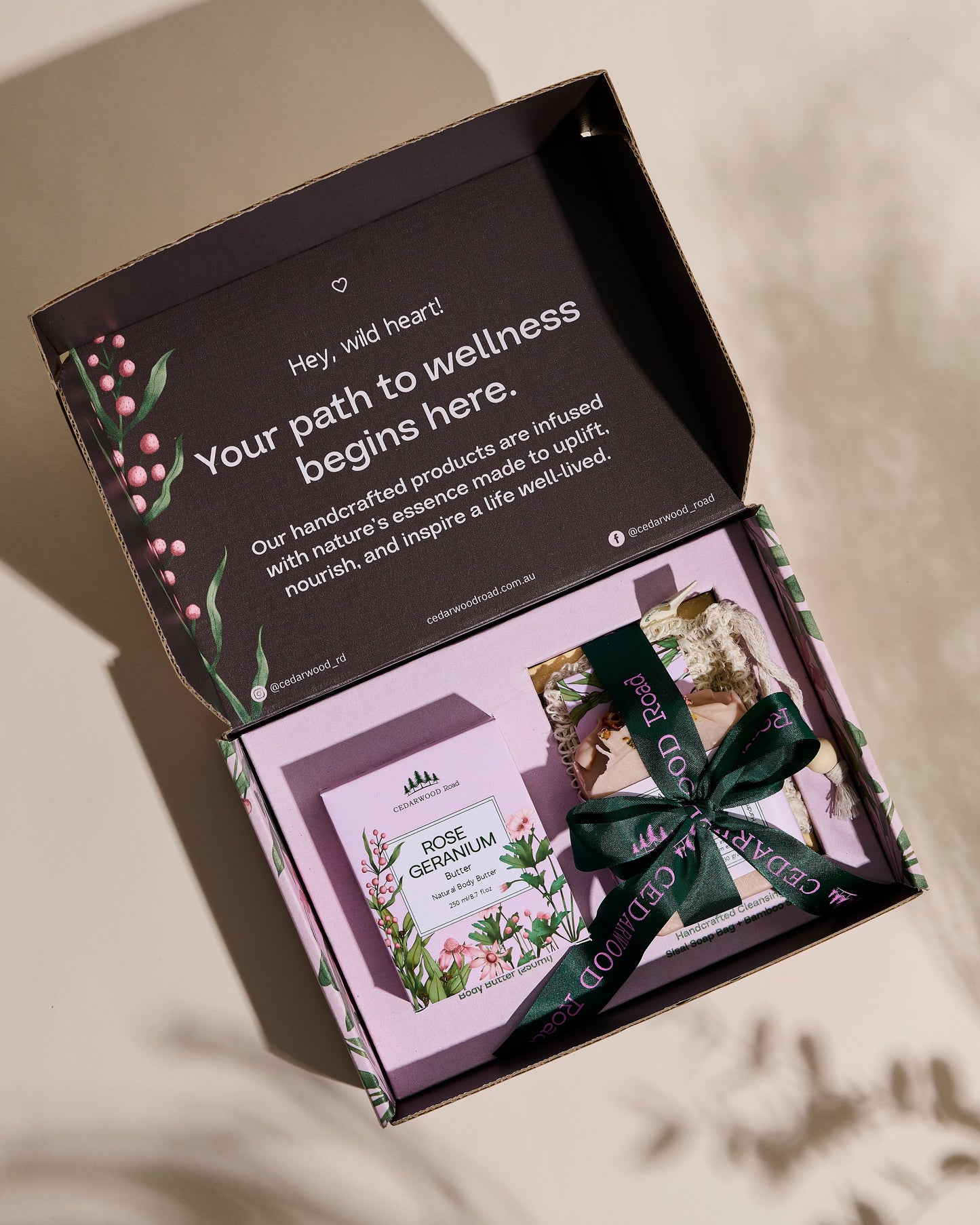 Open box with wellness products and a message about a 'path to wellness' on a neutral background.
